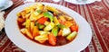 Fried Stir Sweet and sour sauce with slices fresh vegetable in white dish