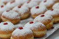 Fried and stuffed sufganiot with strawberry jam, displayed for sale at the Mahane Yehuda market in