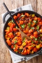 Fried sweet potato black bean chili close-up in a pan. Vertical top view Royalty Free Stock Photo