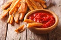 fried sweet potato wedges with herbs and ketchup close-up. horizontal Royalty Free Stock Photo