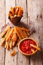 fried sweet potato wedges with herbs and ketchup close-up. Vertical Royalty Free Stock Photo