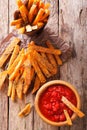 fried sweet potato wedges with herbs and ketchup close-up. vertical top view Royalty Free Stock Photo