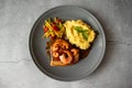 Fried swordfish with prawns in sweet and sour sauce with mashed potatoes and stewed vegetables, seafood plate on a stone table Royalty Free Stock Photo