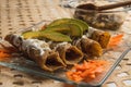 Fried tacos of ground meat and beans, typical Mexican dish, served with cream, cheese, avocado