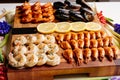 Fried tails of langoustines and fried mussels with sauce and fried shrimps and sliced lemon on wooden cutting board with card and Royalty Free Stock Photo