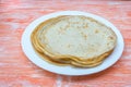 Fried tasty thin slapjack on wooden background Royalty Free Stock Photo