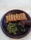 Fried tempeh and green chili sauce are placed on a clay mortar. Tempe is a favorite and cheap food in Indonesia.