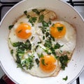 Fried three eggs with fresh green basil leaves Royalty Free Stock Photo