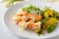 Fried tiger prawn shrimp dish with sugar peas, onion and oranges served with rice and parsley garnish on a white plate, selected Royalty Free Stock Photo