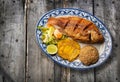 Fried tilapia accompanied with patacon, coconut rice and vegetable salad - Colombian food