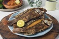 Fried Tilapia fish with cantella asiatica and hot and spicy sauce as side dish Royalty Free Stock Photo