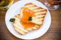 Fried toast with apricot jam in a plate