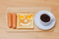 fried toast with eggs and sausages and a cup of coffee Royalty Free Stock Photo