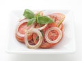 Fried tomatoes witn onion rings and celery leaves Royalty Free Stock Photo
