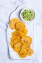Fried tostones, green plantains, bananas with guacamole sauce Royalty Free Stock Photo