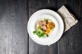 Fried turkey meat steak, sunny side up egg, pasta, pesto sauce and vegetable salad on a white plate. Hot dishes from meat poultry Royalty Free Stock Photo