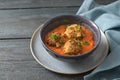 Fried vegetable balls from zucchini and potato in tomato sauce, vegan vegetarian meatball alternative in a blue bowl on a rustic Royalty Free Stock Photo