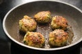 Fried vegetable balls of zucchini, potatoes and ginger in a pan on the stove, healthy cooking vegan and vegetarian, selected focus Royalty Free Stock Photo