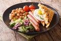 Fried waffles with egg, sausages, beans and fresh salad close-up. horizontal Royalty Free Stock Photo