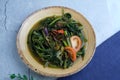 Fried water spinach with shrimp paste or kangkung goreng belacan, a famous Malaysian vegetable