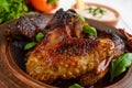 Fried wings duck, chicken in a honey glaze in a clay bowl on a light background.