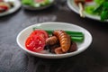 Fried Worm, Insect food with vegetable salad in the white bowl. Healthy meal high protein diet concept. Royalty Free Stock Photo