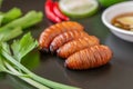 Fried Worm, Insect food with vegetables in the brown plate. Healthy meal high protein diet concept. Royalty Free Stock Photo