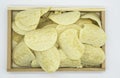 Fried yellow potato chips In wooden tray isolated on white background of file with Clipping Path Royalty Free Stock Photo