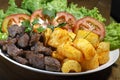 Fried yucca, meat and salad Royalty Free Stock Photo
