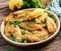 Fried zucchini flowers stuffed with ricotta and green herbs. Vegan food. Royalty Free Stock Photo