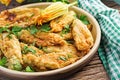 Fried zucchini flowers stuffed with ricotta and green herbs. Vegan food. Royalty Free Stock Photo