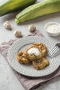 Fried zucchini slices in egg batter with garlic on a plate. Royalty Free Stock Photo