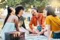 A friend is the best things you can be. a group of friends sitting in a park. Royalty Free Stock Photo