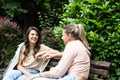 Friend comforting a stressed friend. Two woman young females talking in te park after divorce and abandon abusive husband. Support