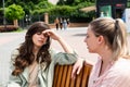 Friend comforting a stressed friend. Two woman young females talking in te park after divorce and abandon abusive husband. Support