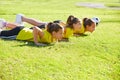 Friend girls teens push-ups workout at park Royalty Free Stock Photo