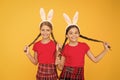 with friend. happy easter. spring is coming. happy childhood concept. small girls bunny ears yellow background. funny Royalty Free Stock Photo