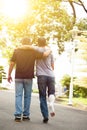 Friend helping brothers or patient to walk on the road Royalty Free Stock Photo