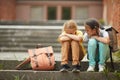 Friend Helping Sad Little Girl in School