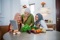 friend with hijab looking at tablet to make new food Royalty Free Stock Photo