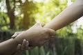 Friend holding hands together at outdoor. Hand holding between colleagues. Friendship and teamwork concept