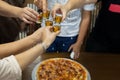 Friend with rum shots on party with pizza on table.