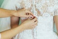 The friend-witness of the bride helps to dress bridal dress bride Royalty Free Stock Photo