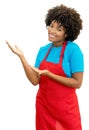 Friendly african american clerk or waitress inviting guests Royalty Free Stock Photo