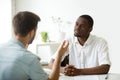 Friendly African American employer listening to work candidate d Royalty Free Stock Photo