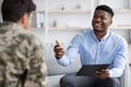 Friendly african american psychologist having conversation with soldier Royalty Free Stock Photo