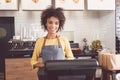 Friendly african woman laboring with pleasure in healthy food cafe