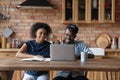 Friendly afro american married couple study from home using laptop Royalty Free Stock Photo