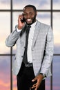 Friendly afro man with cellphone. Royalty Free Stock Photo