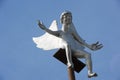 Friendly Angel sitting on pole on mountaintop